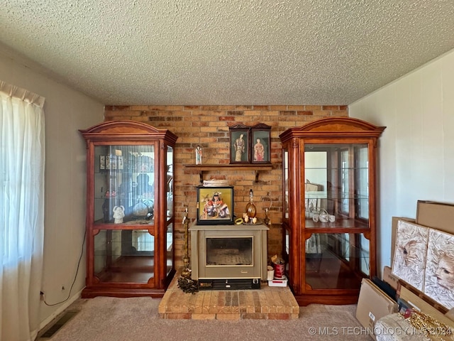 living room featuring carpet flooring, a wealth of natural light, a fireplace, and a textured ceiling