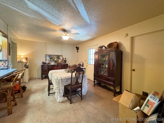 bedroom with a textured ceiling, light colored carpet, and ceiling fan