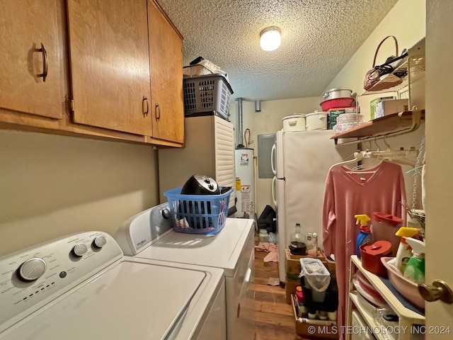 laundry room with cabinets, a textured ceiling, gas water heater, hardwood / wood-style floors, and washing machine and dryer