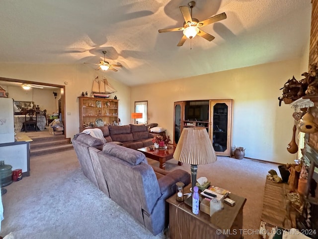 carpeted living room with a textured ceiling, ceiling fan, and vaulted ceiling