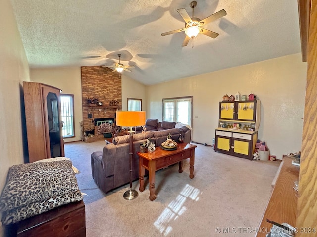 carpeted living room with a textured ceiling, ceiling fan, a fireplace, and vaulted ceiling