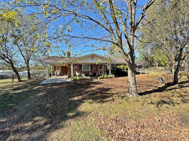 view of front facade featuring a front lawn and a carport