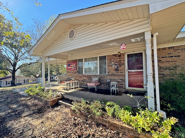 doorway to property featuring a porch