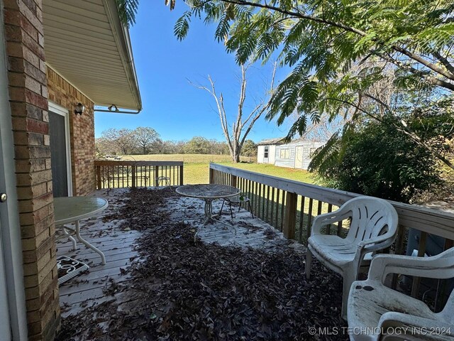 613 S Rodgers St, Vian, OK 74962 - deck with an outbuilding