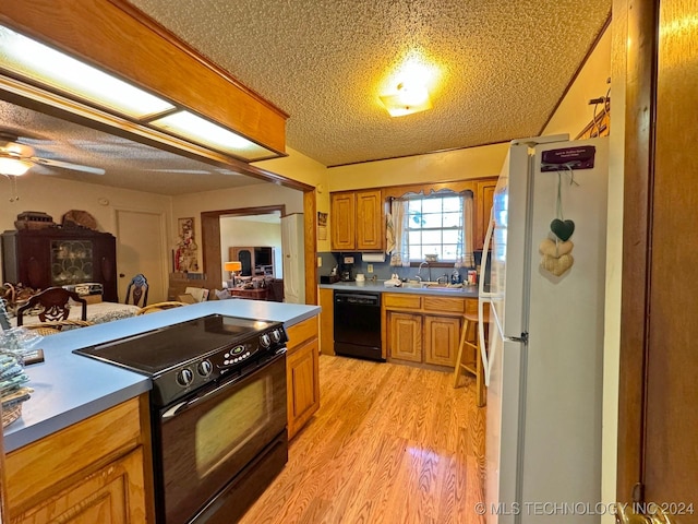 613 S Rodgers St, Vian, OK 74962 - kitchen featuring black appliances, light wood-type flooring, a textured ceiling, brown cabinets, and ceiling fan
