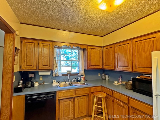 613 S Rodgers St, Vian, OK 74962 - kitchen featuring black appliances, a textured ceiling, brown cabinetry, and light countertops