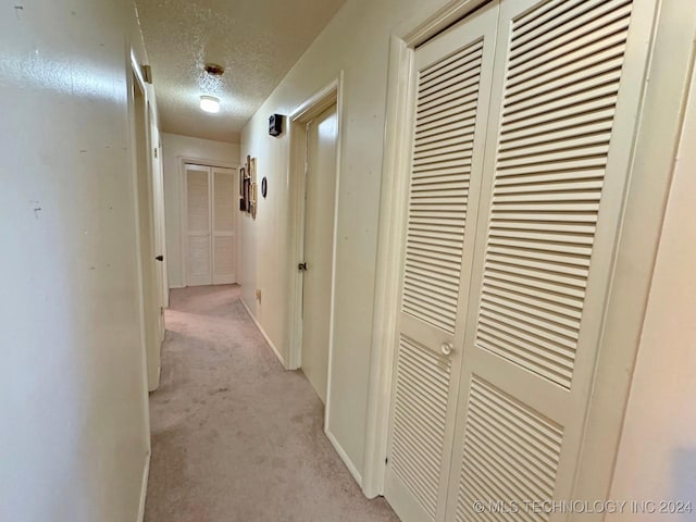 613 S Rodgers St, Vian, OK 74962 - hallway featuring light carpet and a textured ceiling