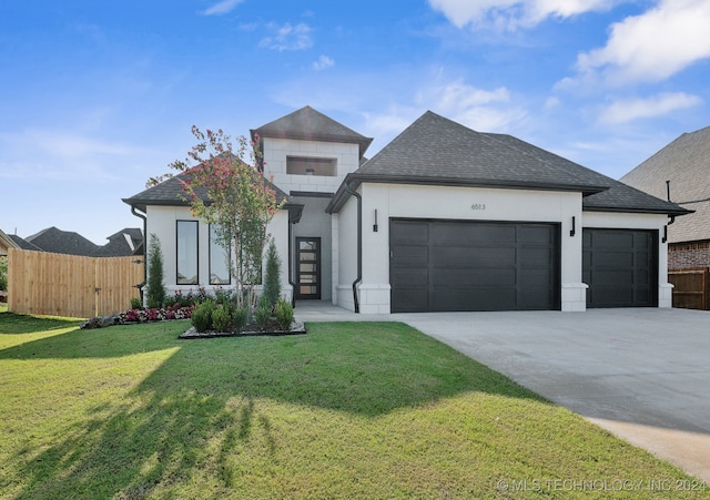 view of front of home featuring a front yard and a garage