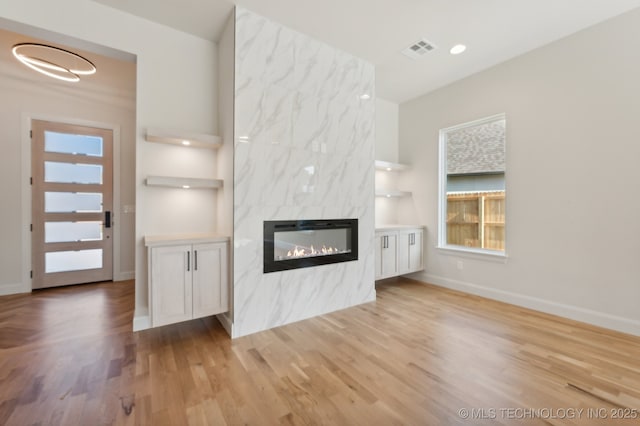 unfurnished living room with light hardwood / wood-style floors and a fireplace