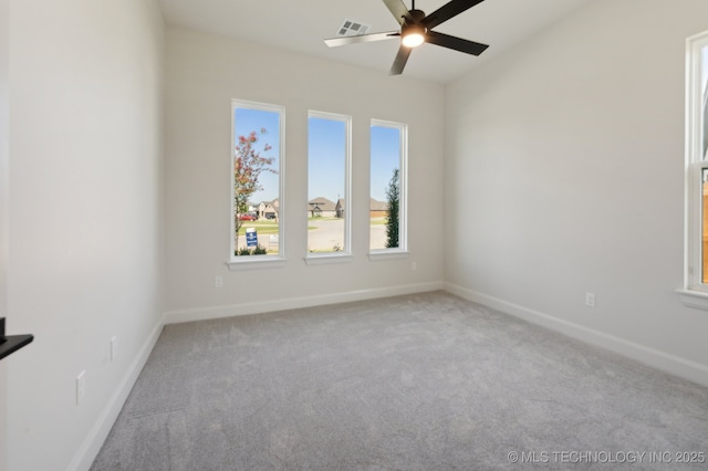 carpeted spare room with ceiling fan