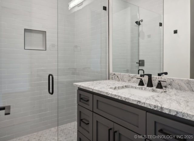 bathroom with vanity and walk in shower