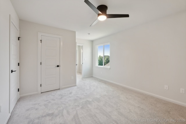 unfurnished bedroom featuring ceiling fan and light colored carpet