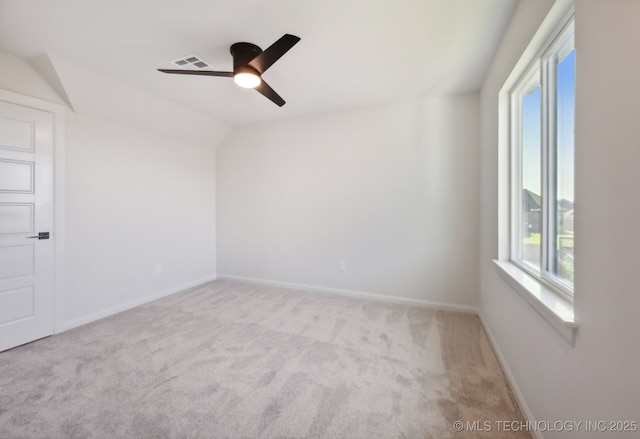 unfurnished room featuring ceiling fan, vaulted ceiling, and light carpet