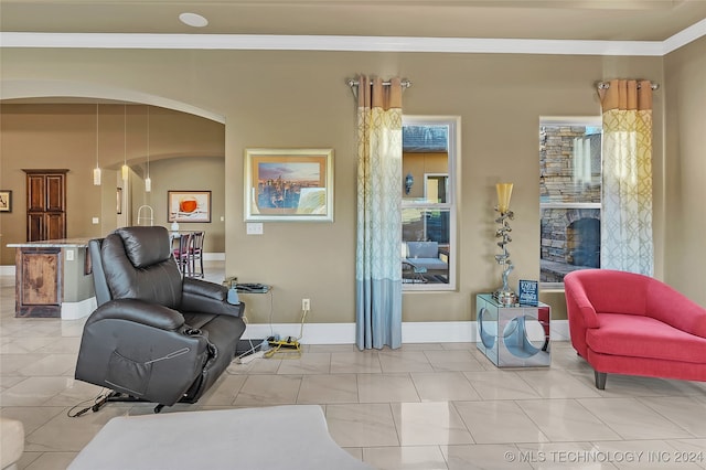 sitting room featuring ornamental molding and light tile patterned floors