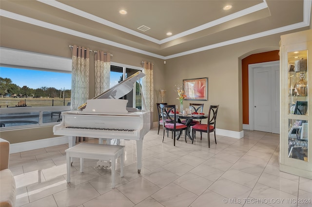 miscellaneous room featuring light tile patterned floors, a raised ceiling, and ornamental molding