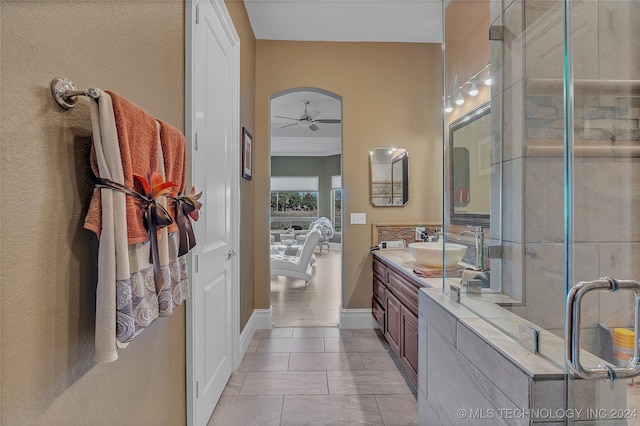 bathroom with tile patterned flooring, ceiling fan, and vanity