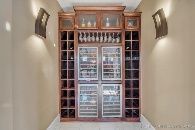 wine area with wine cooler and light tile patterned floors