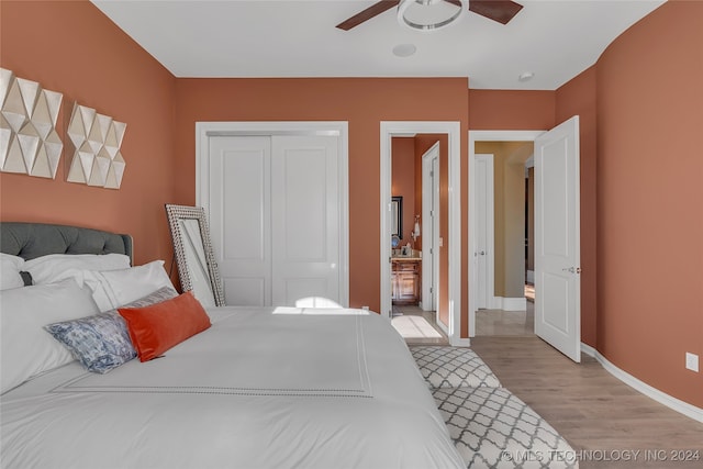 bedroom featuring ceiling fan, a closet, and light hardwood / wood-style floors