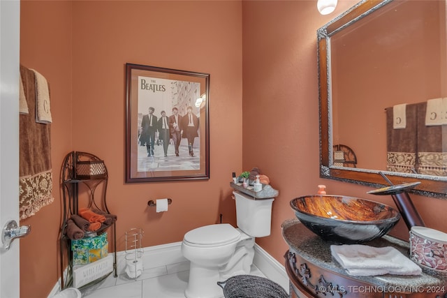 bathroom featuring tile patterned floors, toilet, and sink