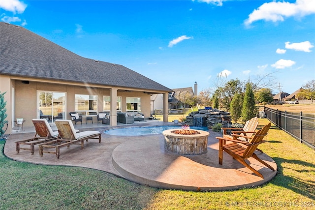 view of pool featuring a yard, an outdoor living space with a fire pit, and a patio area