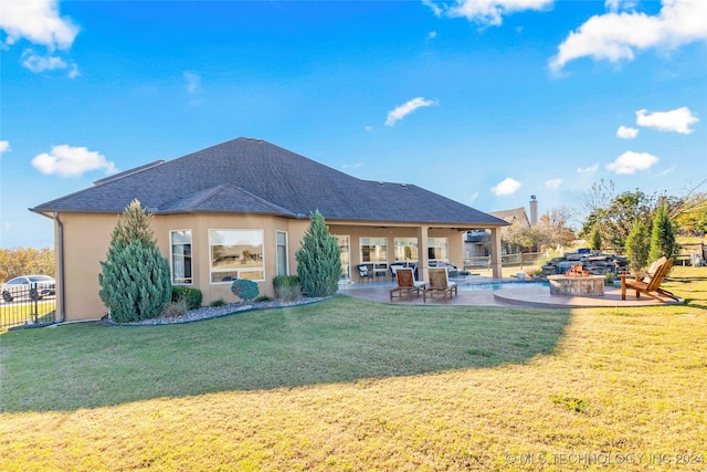 rear view of house with a yard and a patio