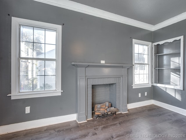 unfurnished living room featuring a fireplace, a textured ceiling, dark hardwood / wood-style flooring, and ornamental molding