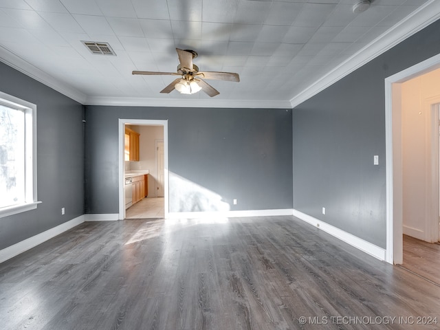 empty room with ceiling fan, wood-type flooring, and ornamental molding