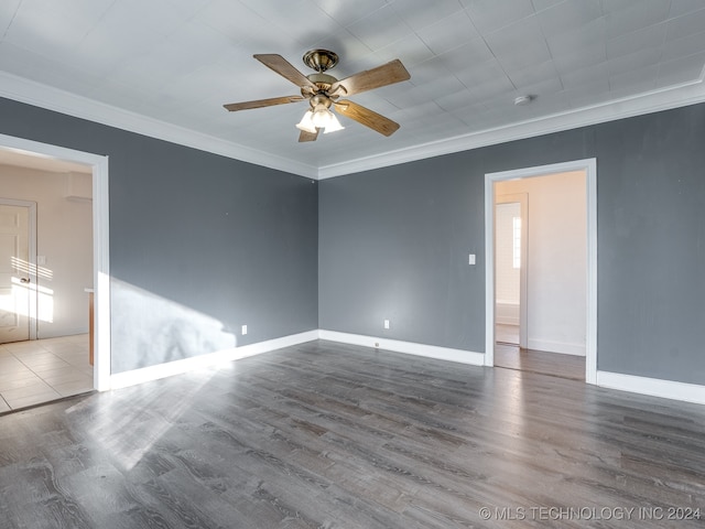 empty room featuring ceiling fan, hardwood / wood-style floors, and ornamental molding