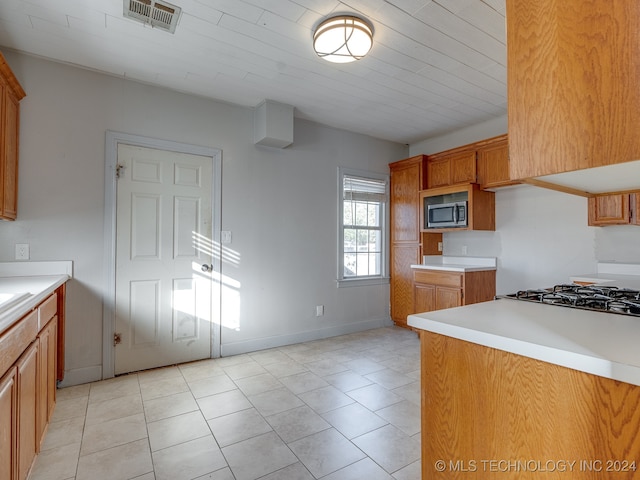 kitchen with light tile patterned floors and stainless steel appliances