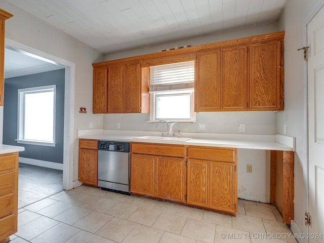 kitchen with a wealth of natural light, dishwasher, sink, and light tile patterned floors