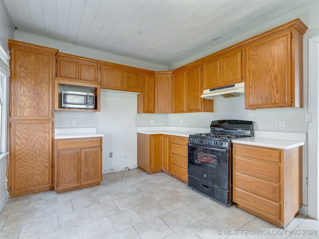 kitchen with black gas range oven and crown molding