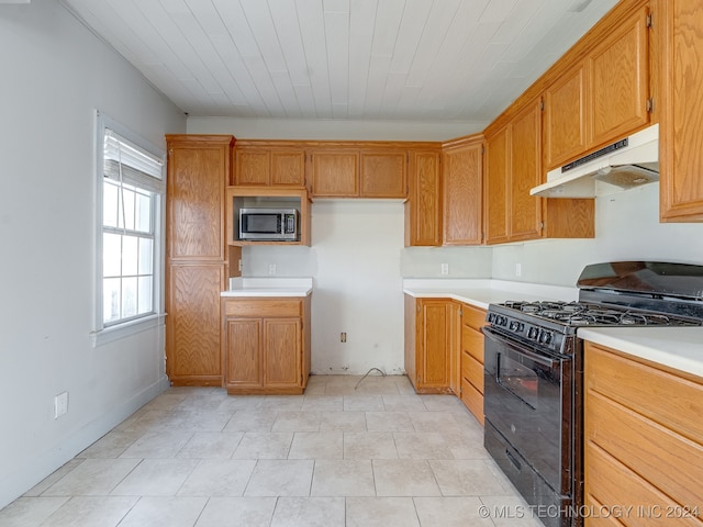 kitchen with light tile patterned floors and black range with gas cooktop