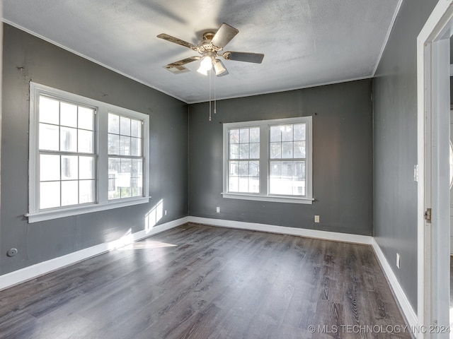 spare room with ceiling fan, dark wood-type flooring, and a textured ceiling