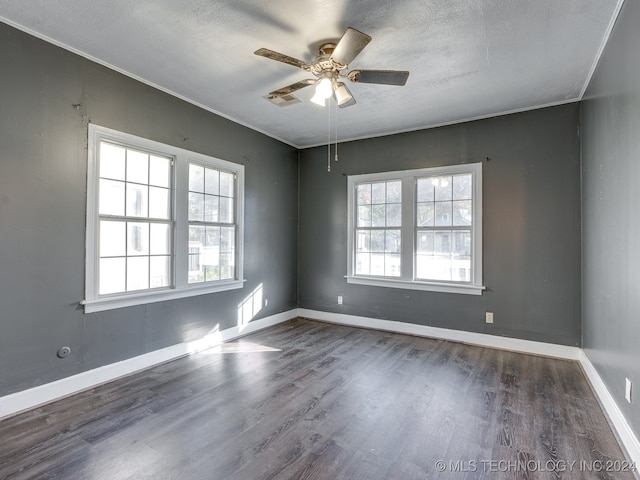 unfurnished room with ornamental molding, a textured ceiling, ceiling fan, and dark wood-type flooring