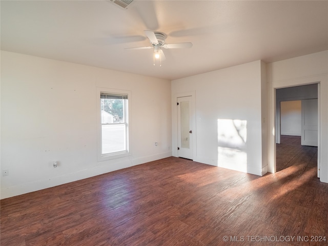 unfurnished room featuring ceiling fan and dark wood-type flooring