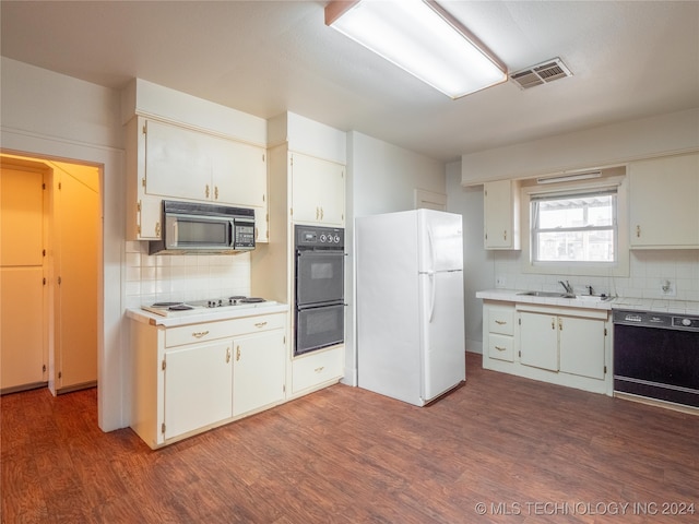 kitchen featuring decorative backsplash, sink, dark wood-type flooring, and black appliances