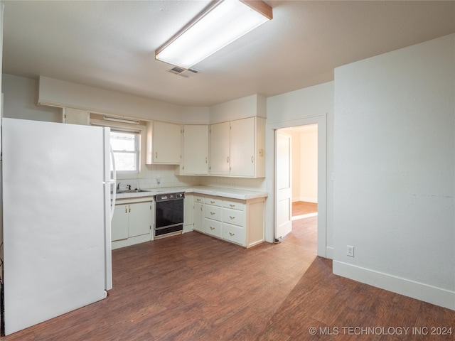 kitchen with sink, decorative backsplash, black dishwasher, white fridge, and wood-type flooring