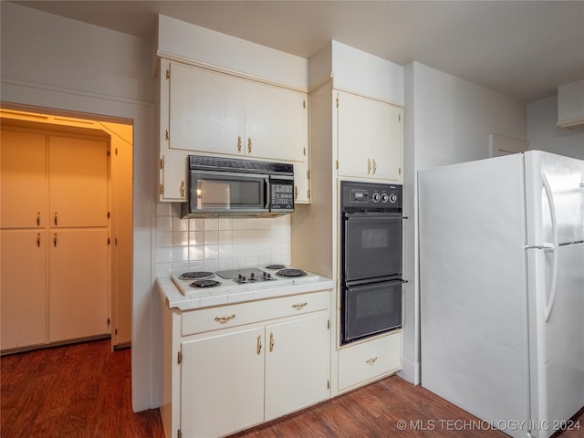 kitchen with tasteful backsplash, dark wood-type flooring, black appliances, white cabinetry, and tile counters