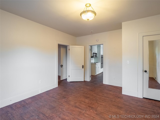 unfurnished room featuring dark hardwood / wood-style flooring