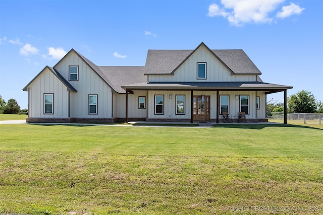 view of front of home featuring covered porch and a front lawn