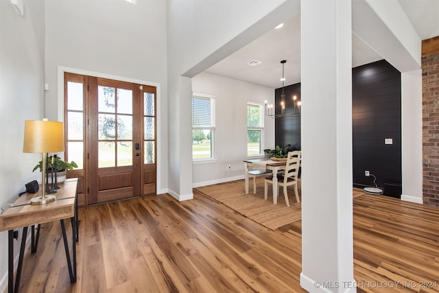 entrance foyer featuring hardwood / wood-style floors and a chandelier