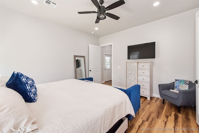 bedroom with ceiling fan and hardwood / wood-style floors