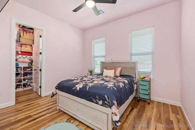 bedroom with hardwood / wood-style floors and ceiling fan