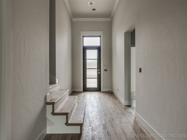 entryway featuring crown molding and light hardwood / wood-style flooring