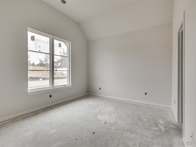 spare room with vaulted ceiling