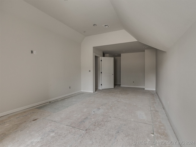 additional living space featuring vaulted ceiling