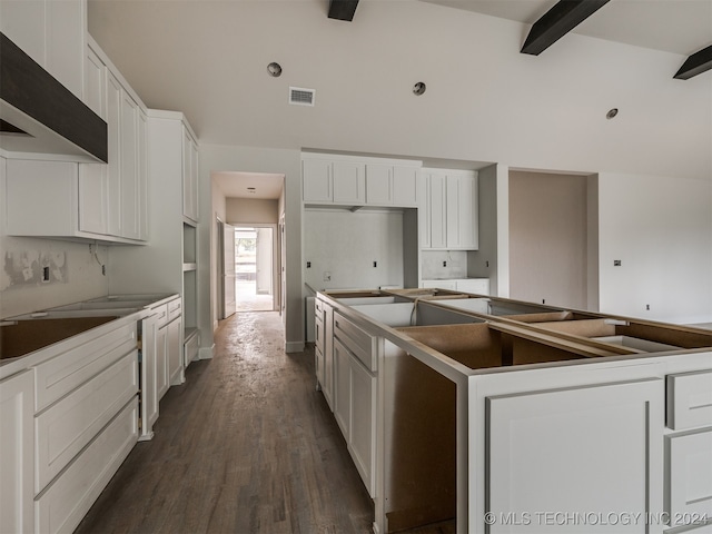 kitchen featuring a center island, vaulted ceiling with beams, range hood, white cabinets, and hardwood / wood-style flooring