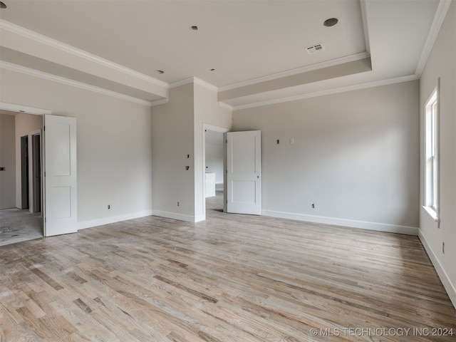 unfurnished living room featuring light hardwood / wood-style flooring and ornamental molding