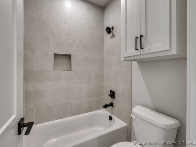 bathroom featuring toilet and tiled shower / bath combo