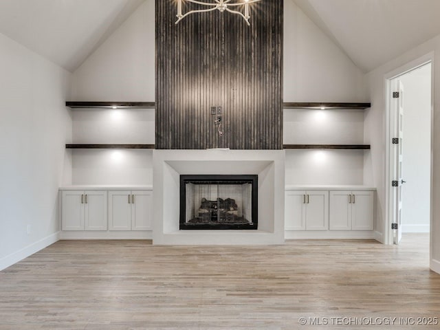 unfurnished living room with lofted ceiling and light hardwood / wood-style flooring